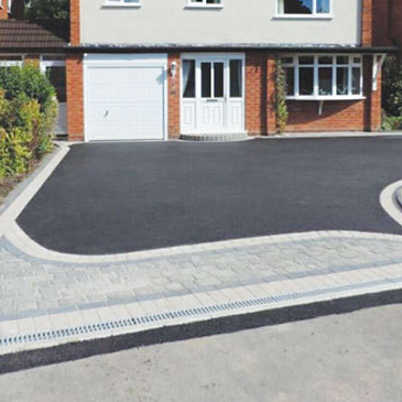 Tarmac driveway with a block paved border and channel drainage